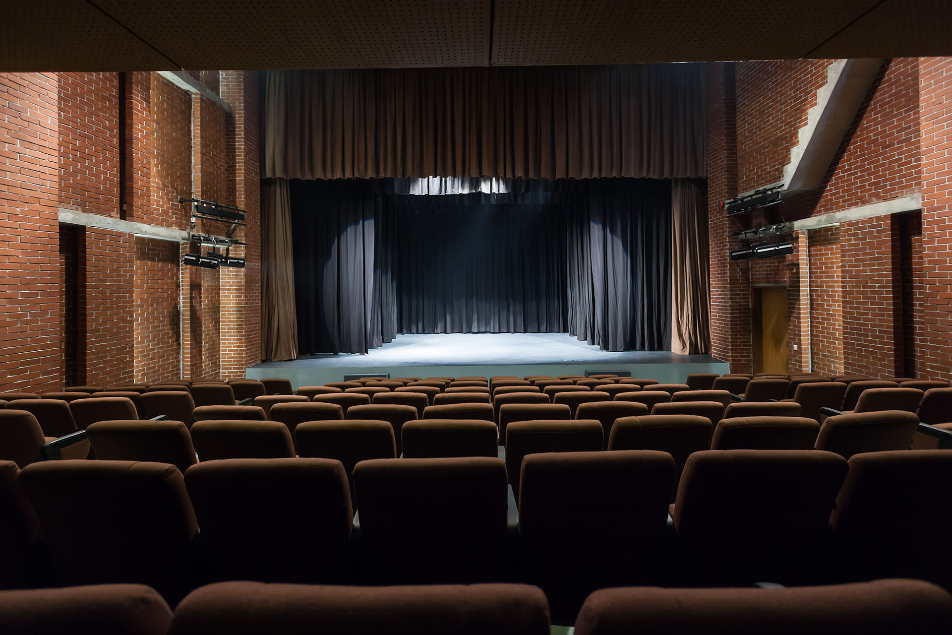 <p>Theater hall enclosed with red brick wall</p>