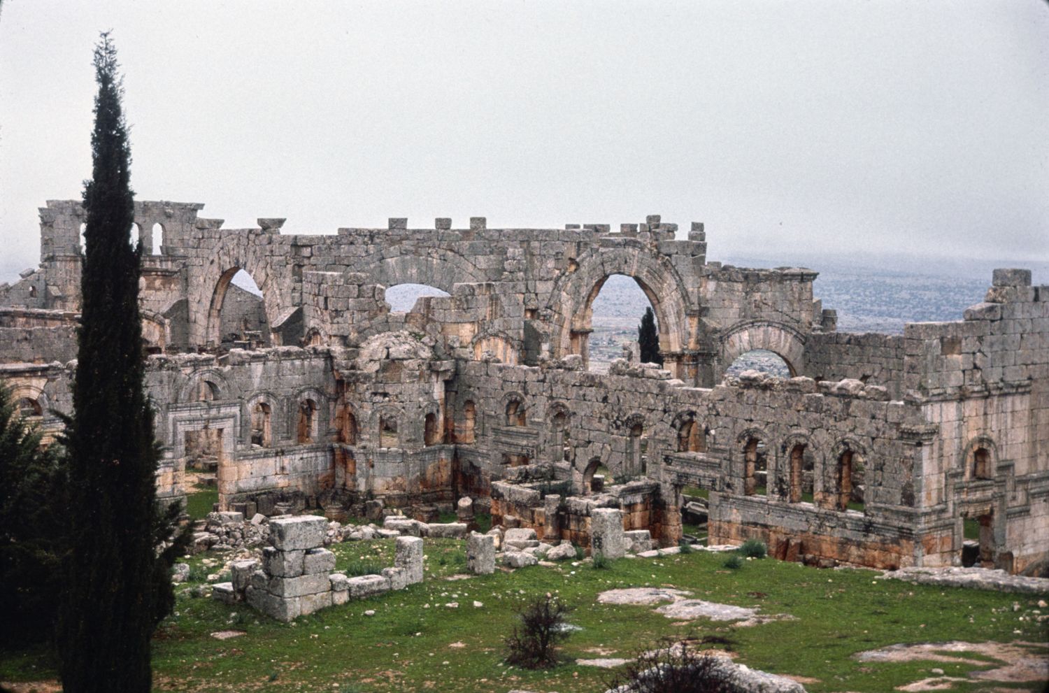Martyrium, exterior view from northeast showing exterior walls of north and east basilicas. The walls of the central octagonal chamber rise in the background.