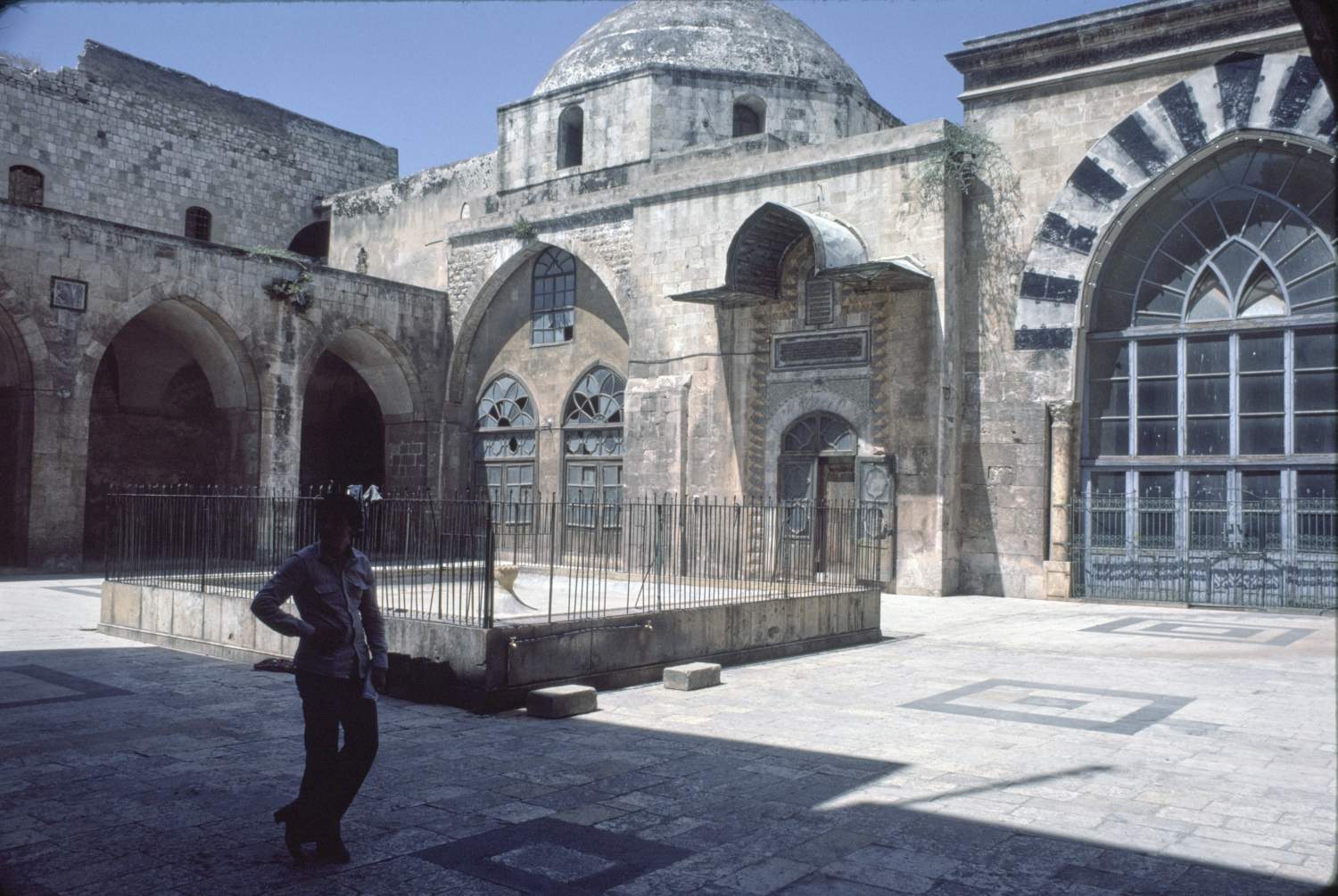 View of courtyard facing southwest. Entrance to iwan visible at right and double entrance to domed sanctuary at left.