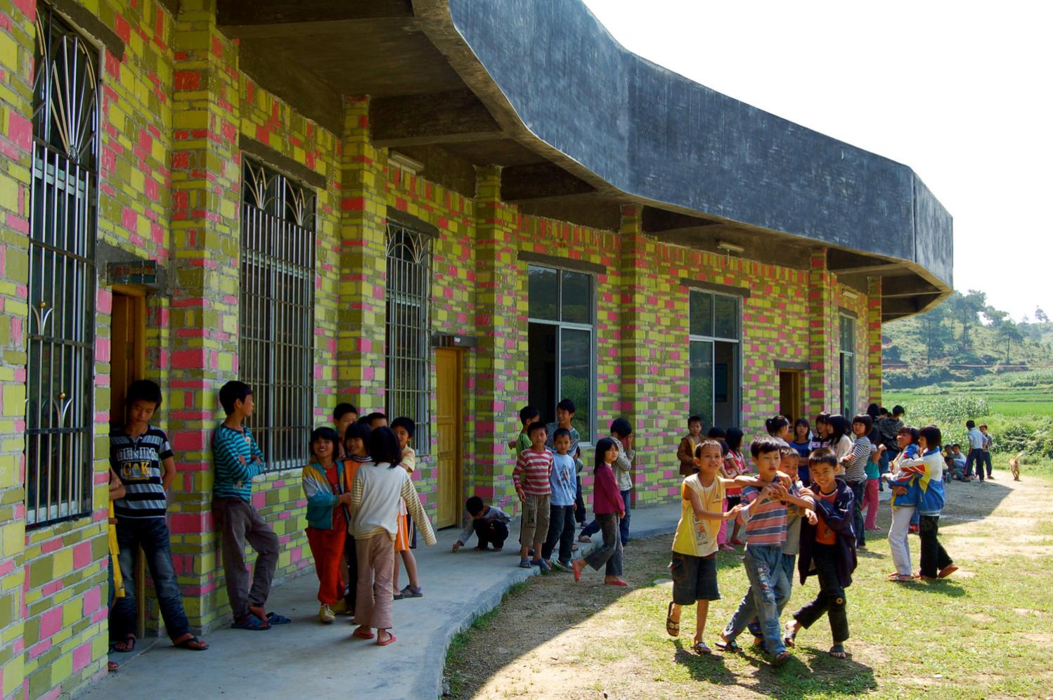 School children outside classroom with view towards terraces