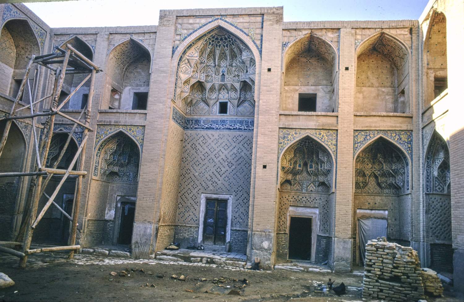 View of west facade of courtyard, showing western iwan and adjacent arcades.