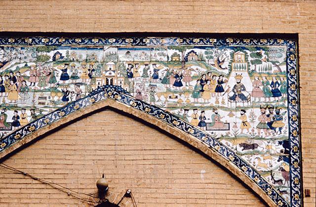 Exterior detail view showing tile panel in the spandrel of arch