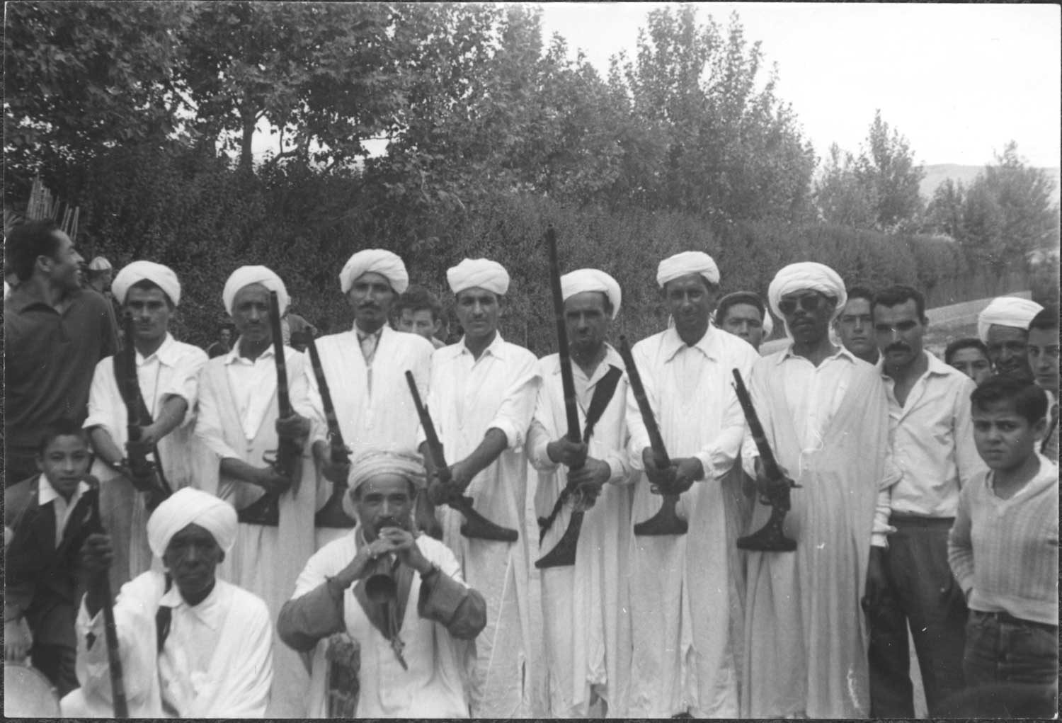 View of the men from the Allal ben Mohammed Kaaoui Ensemblemble with their rifles and a ghaita 