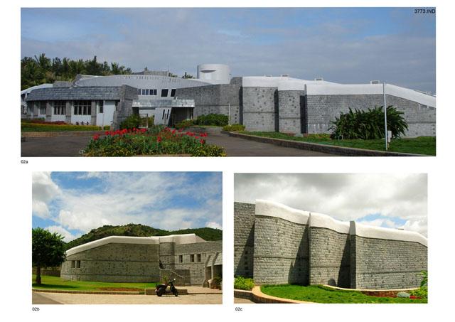 View of main entrance from driveway; view of auditorium and part shops; the external walls of the auditorium