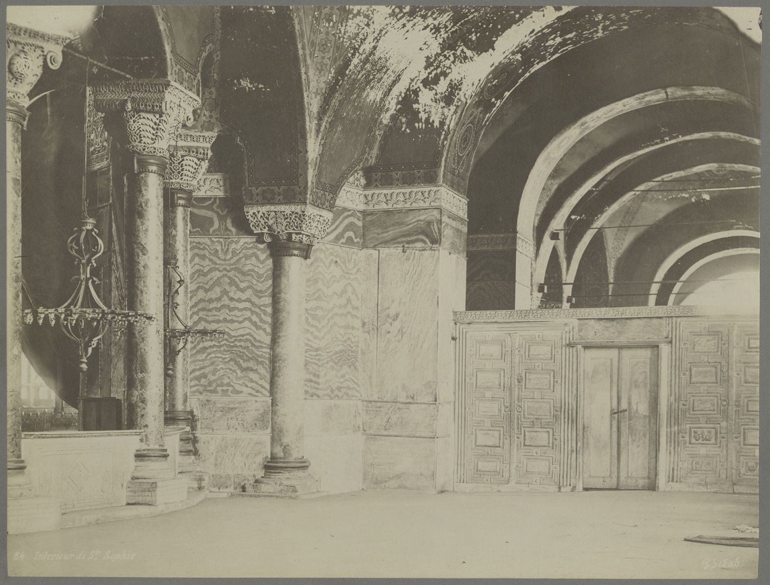 Upper galleries: view of marble doors and quarter-sawn marble decoration.