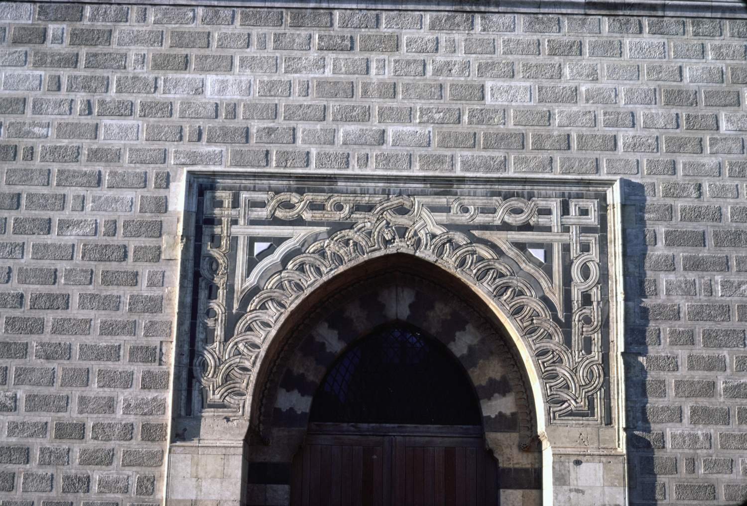 View of upper half of modern entrance portal. 