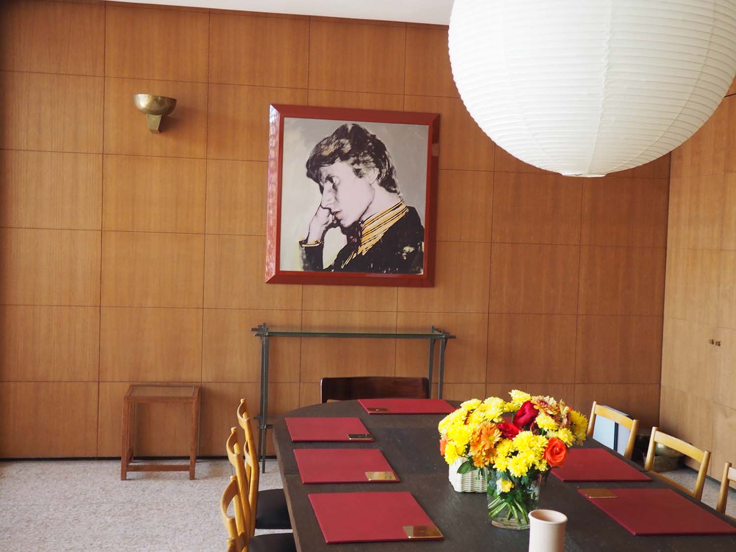 View of meeting room; portrait of Yves Saint Laurent by Andy Warhol on wall