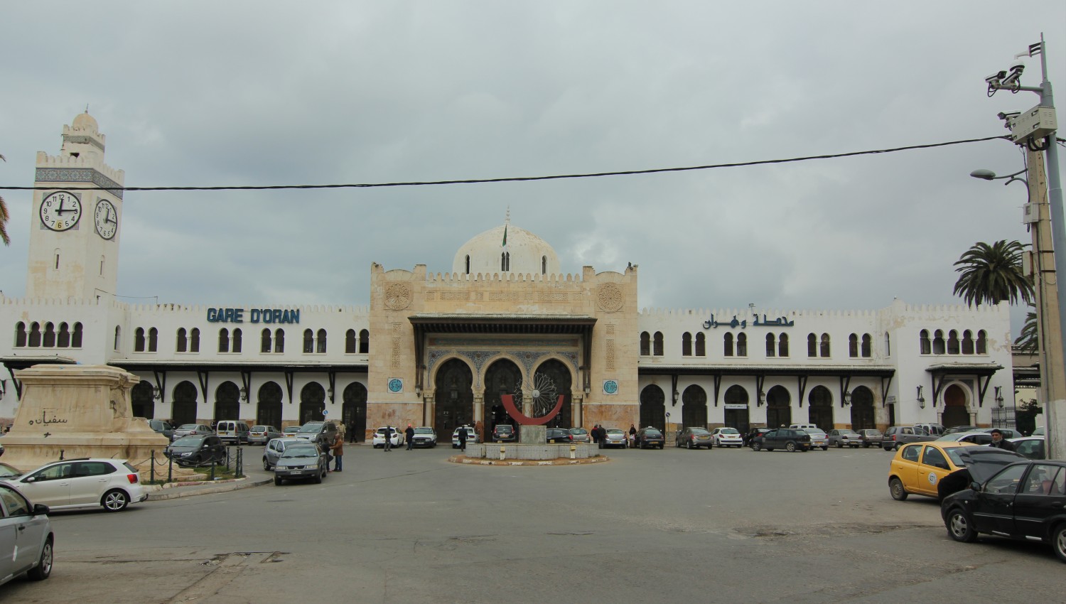 Frontal view of the train station showing the main entrance and minaret-style clock tower
