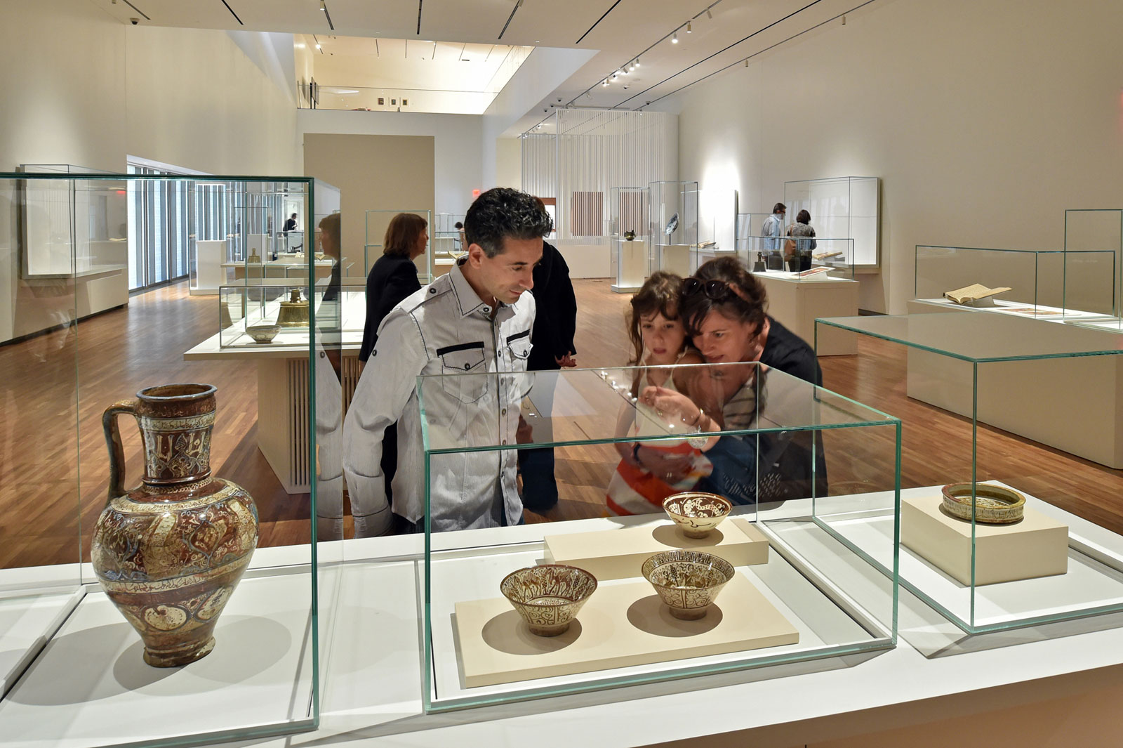 Interior view of a gallery, people viewing items