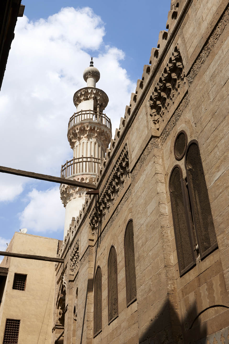 Exterior, upwards view along facade to minaret
