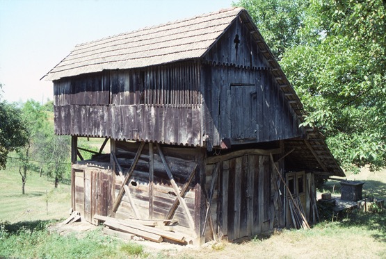 <p>This smaller structure has its major openings and side elevation toward the dwelling. The combination of braced exterior structure at its base and interior structure with cladding on the upper level is consistent with the methods used in the timber and plank older dwellings of the region. The bracing elements are let into one another and the vertical and horizontal members to provide greater strength for the wood frame.</p>
