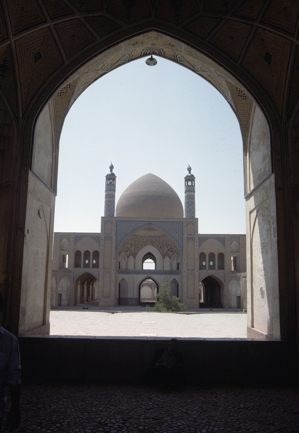 View through arch of entrance pavilion facing southeast across courtyard toward <span style="font-style: italic;">gunbad-khanah</span> assemblage.