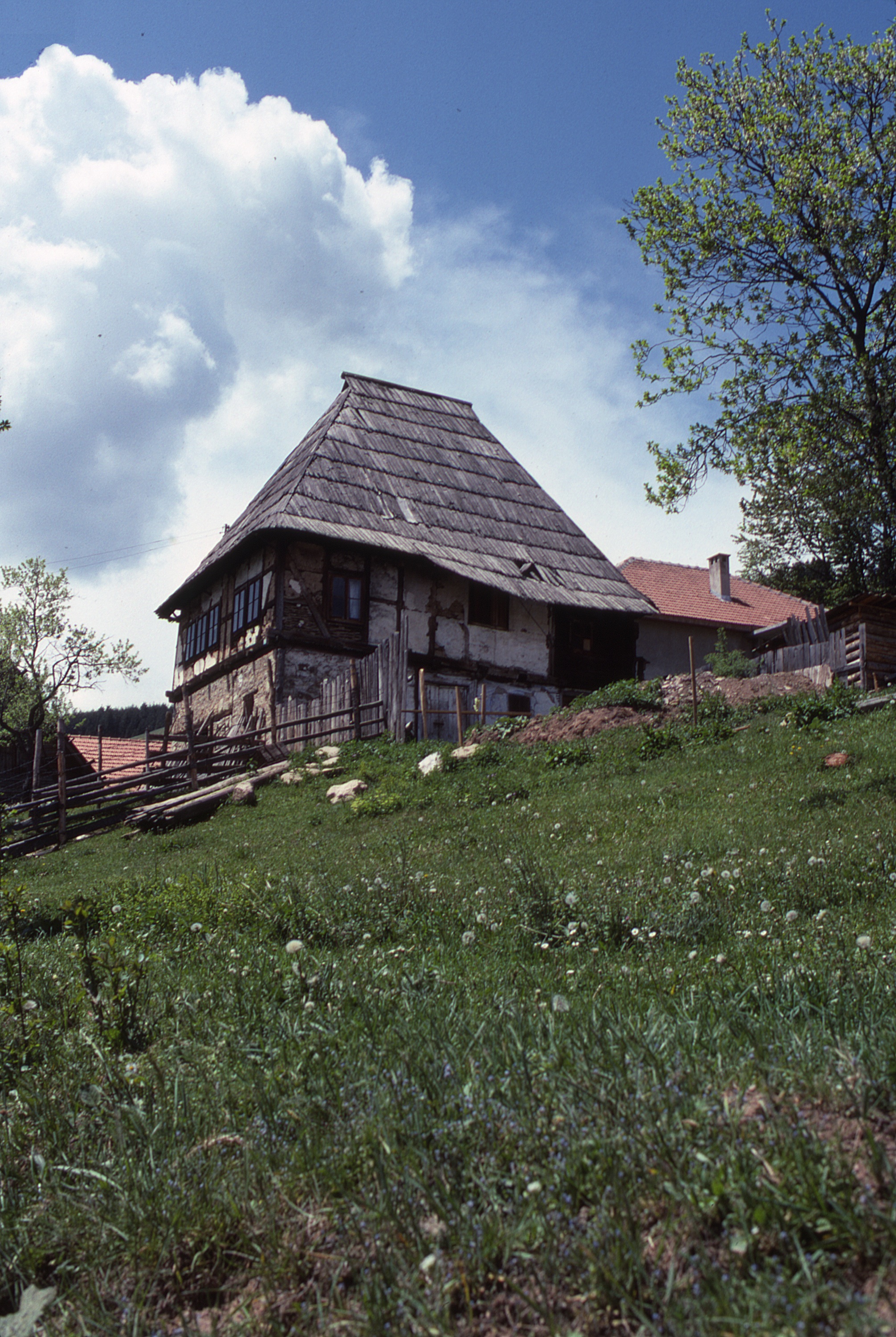 <p>Rožaje is an old town in northeastern Montenegro, with medieval origins, and this is a typical house in this mountainous region. In this variation of the Dinaric mountain house, the living spaces are elevated, formed of timber frame construction with a wattle and daub infill above a masonry base. The steep roof is typical of Dinaric houses and the exposed diagonal bracing on the upper level, left exposed or covered with a plaster material, a wall treatment commonly found in this region.</p>