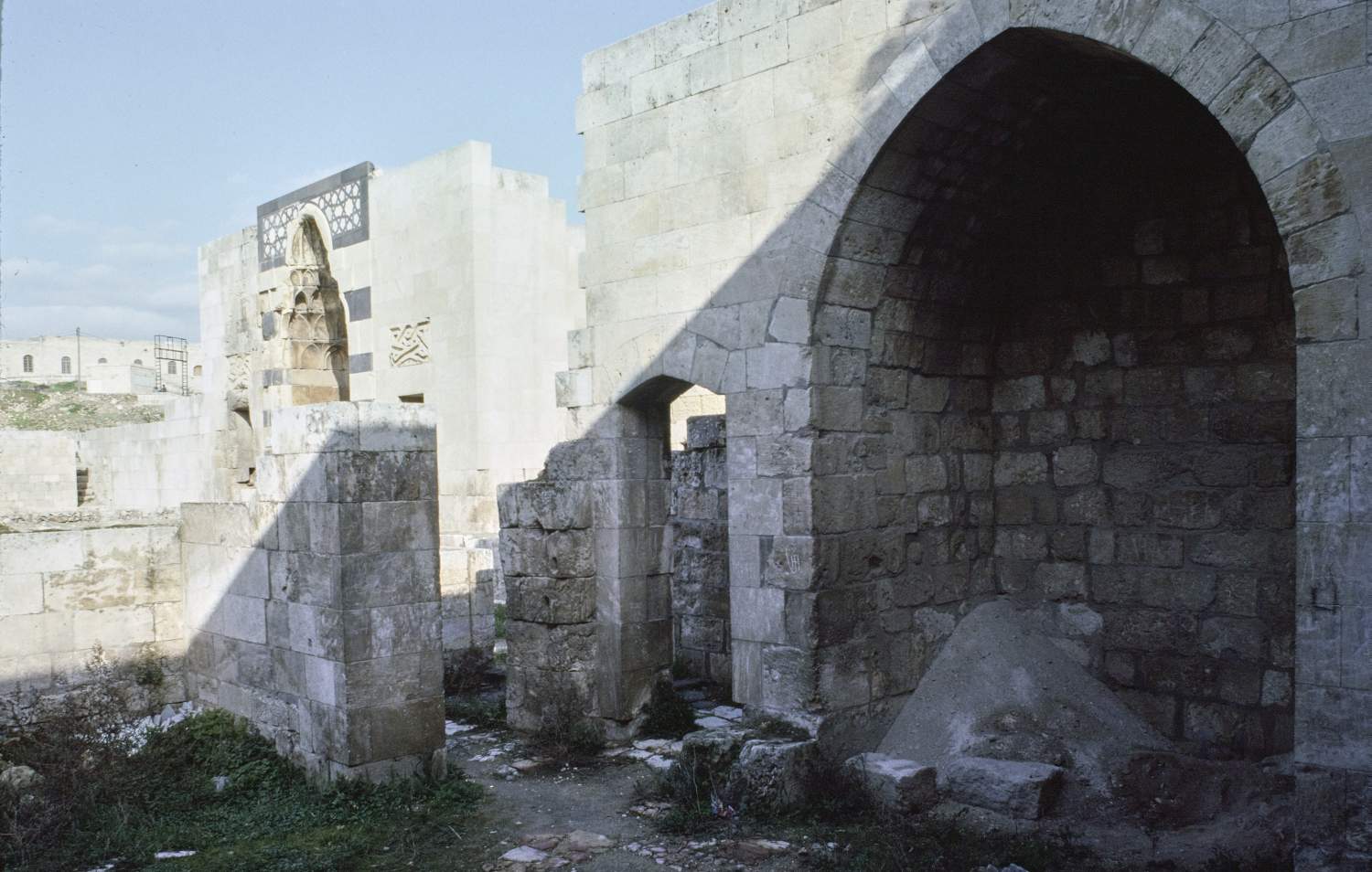 View from within structure south of Palace of al-Malik al-Zahir Ghazi, facing northeast toward entry portal to palace.
