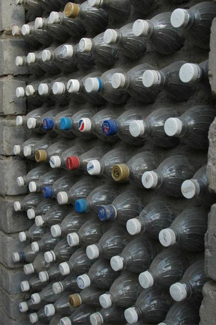 Used plastic bottles filled with waste/ash applied as brick of the wall