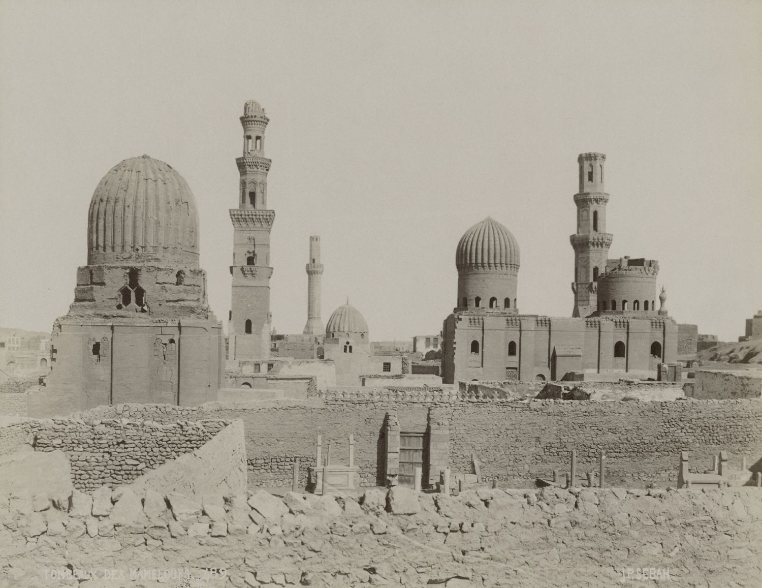 View of monuments in Cairo's Southern Cemetery: Tomb of Qawsun (front left), Sultaniyya Complex (middle right), and Nur al-Din Mosque (back center).