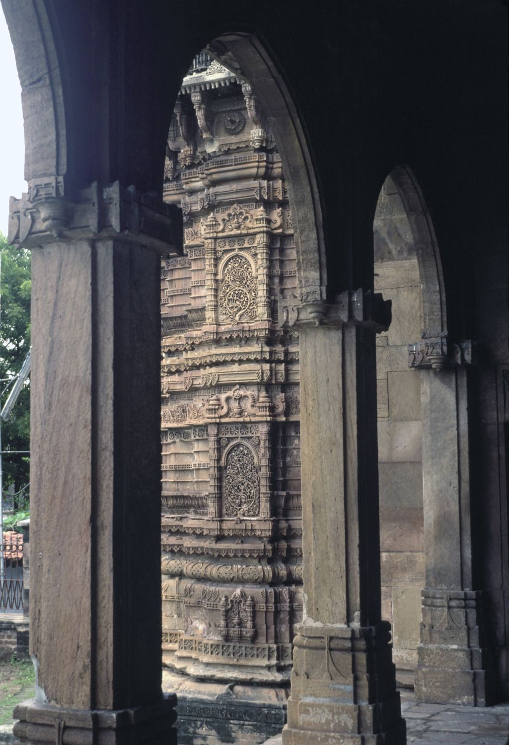 View from inside prayer hall out through front arcade. The buttress on the south end of the facade is visible.