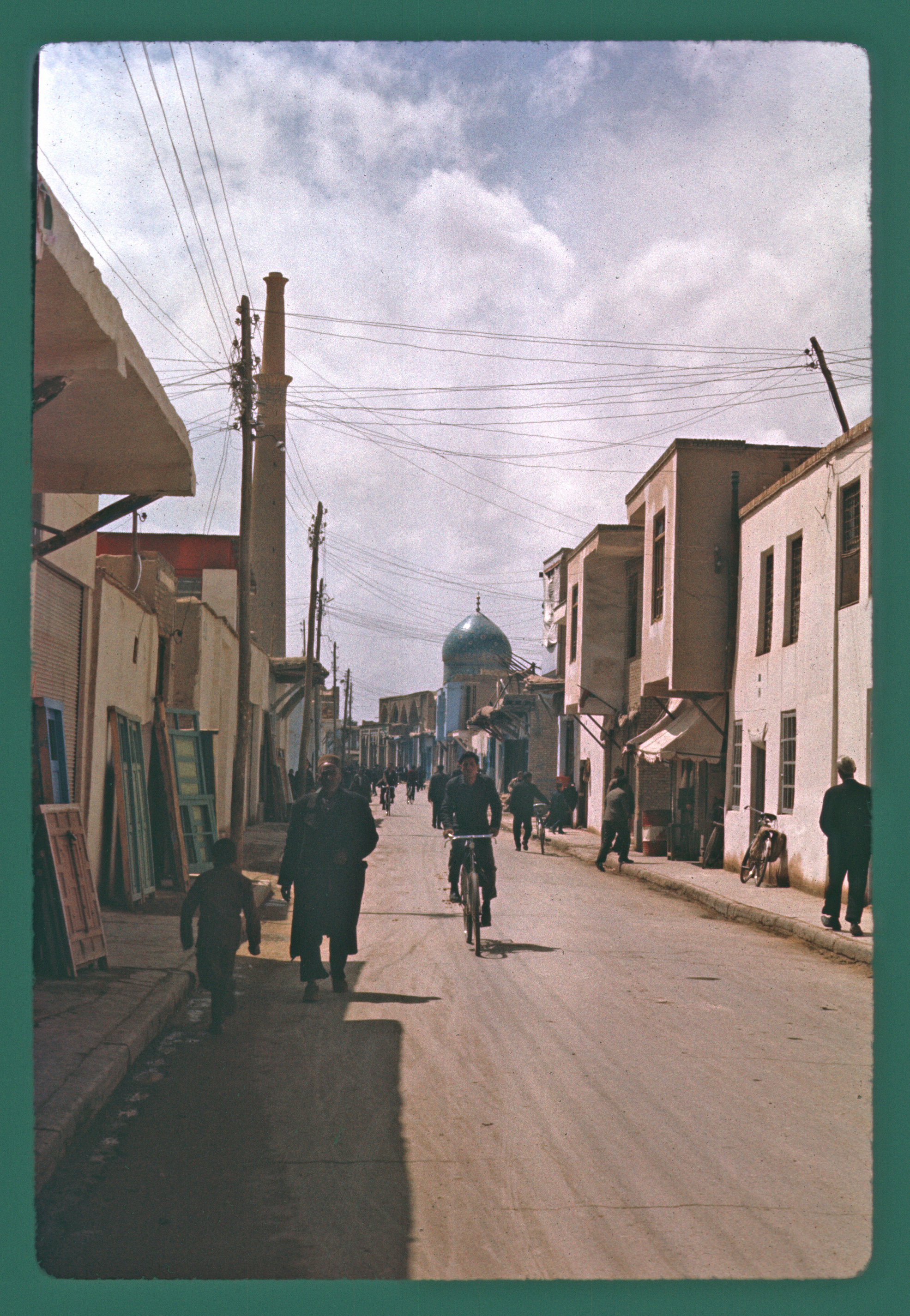 View of a street in Isfahan. The minaret of Masjid-i 'Ali and dome of adjacent Harun-i Vilayat Shrine are visible in background.