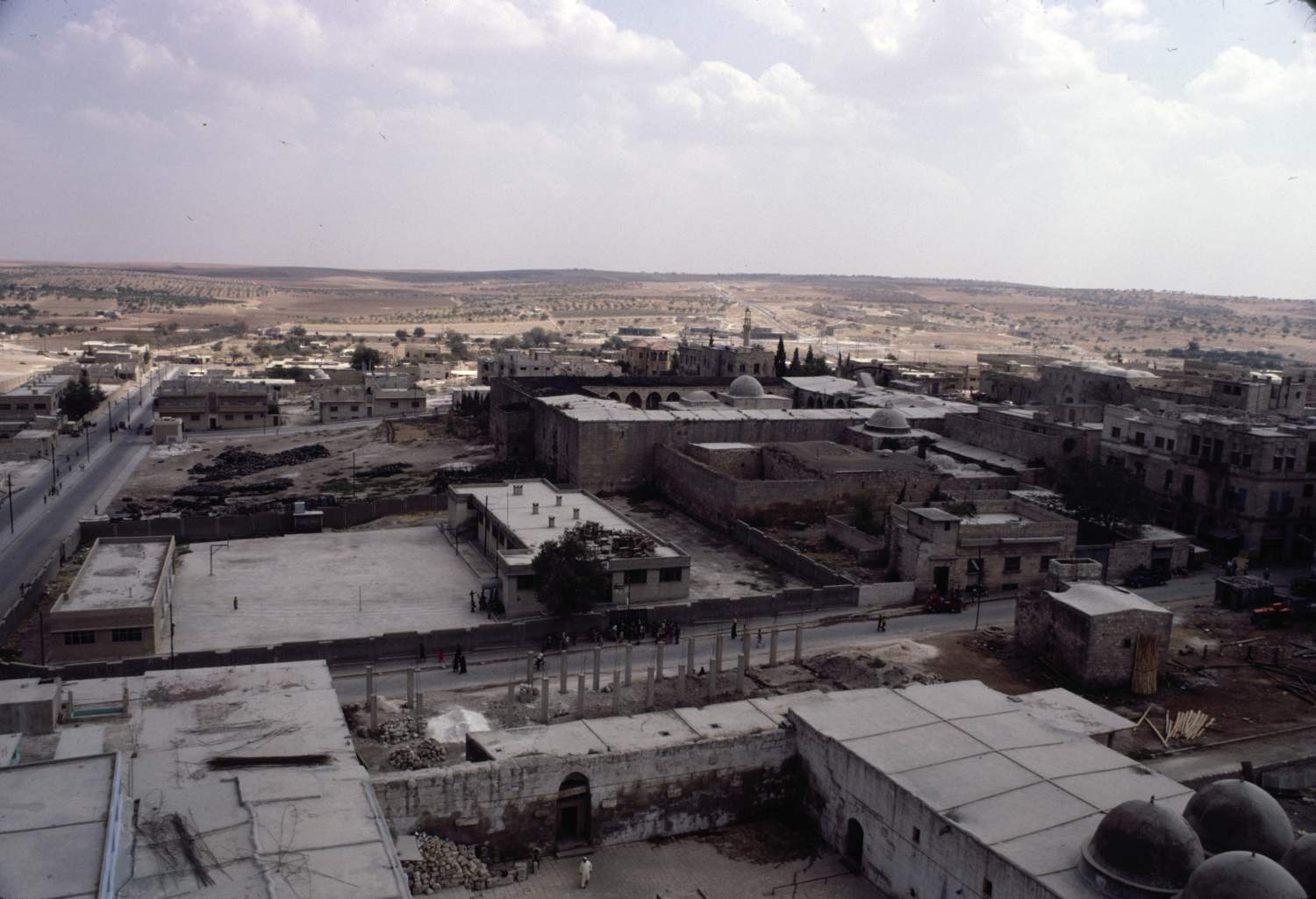 General view of Ma'arrat al-Na'aman from Great Mosque minaret, facing east. The east end of the mosque's courtyard is visible in foreground.