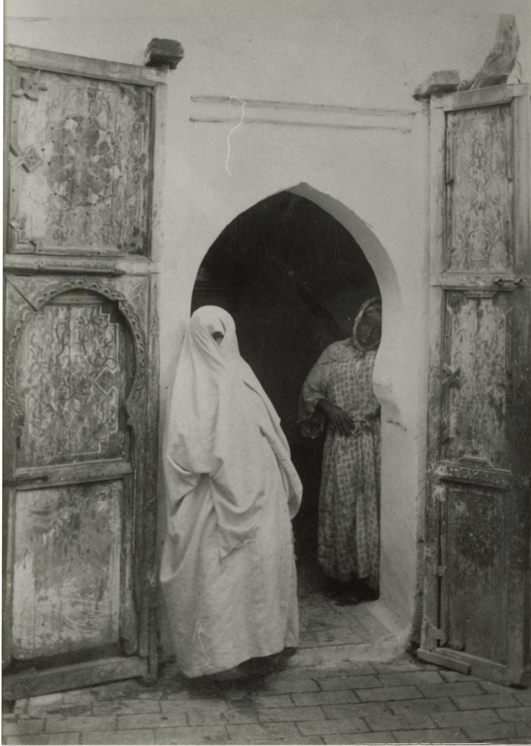 Two veiled women in a doorway