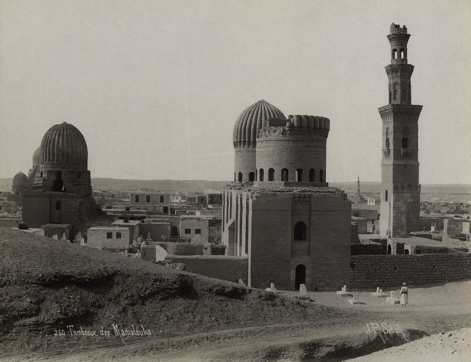 View of monuments in Cairo's Southern Cemetery. The Qubba al-Sultaniyya is visible in foreground, and the tomb of Amir Qawsun is visible at left.