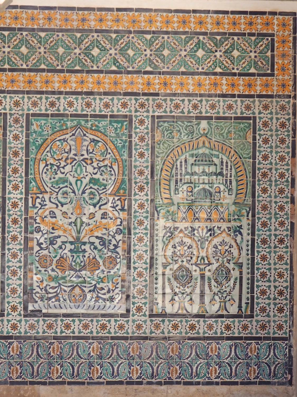 View of decorative tile with floral and architectural motifs