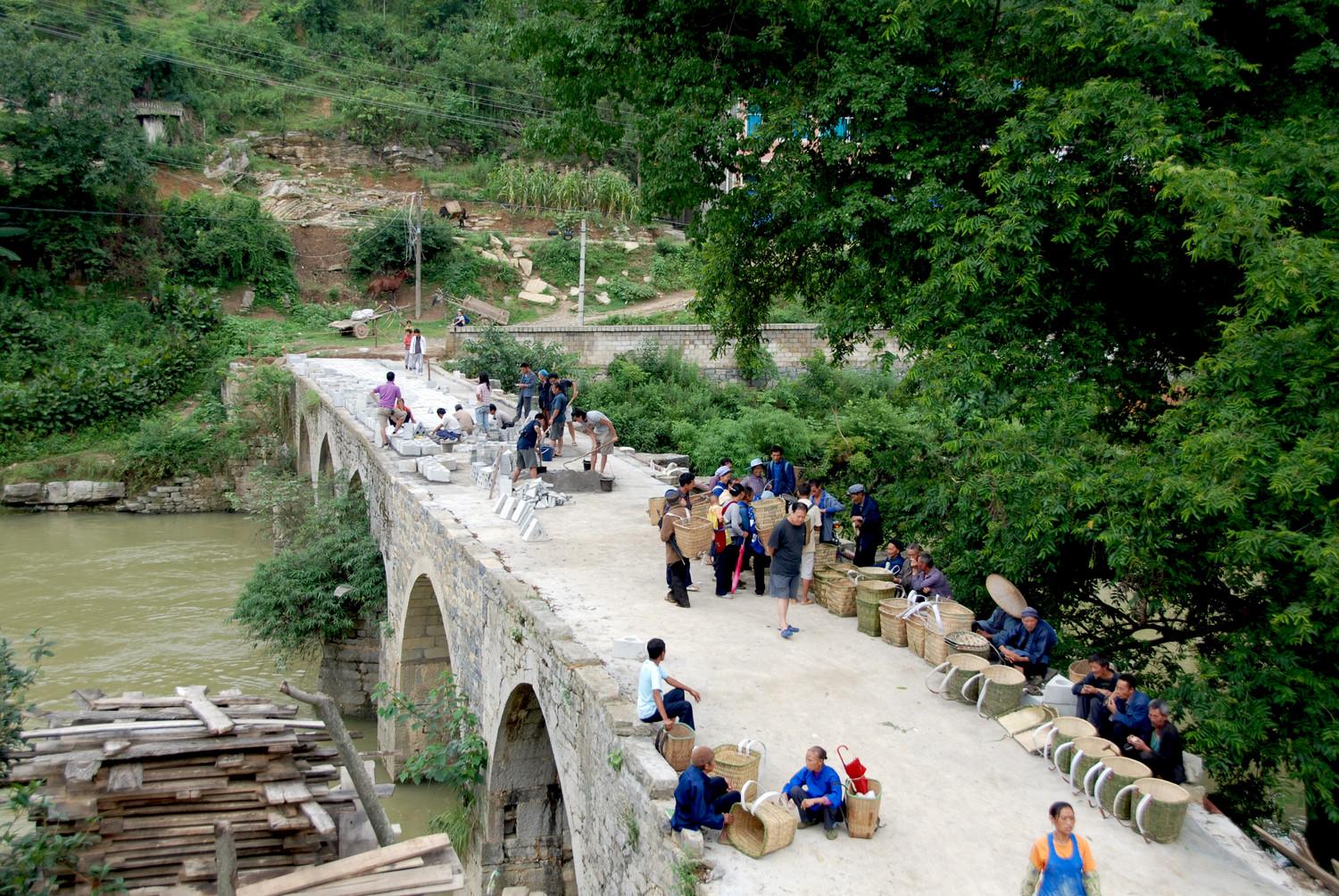 Villagers on bridge during construction