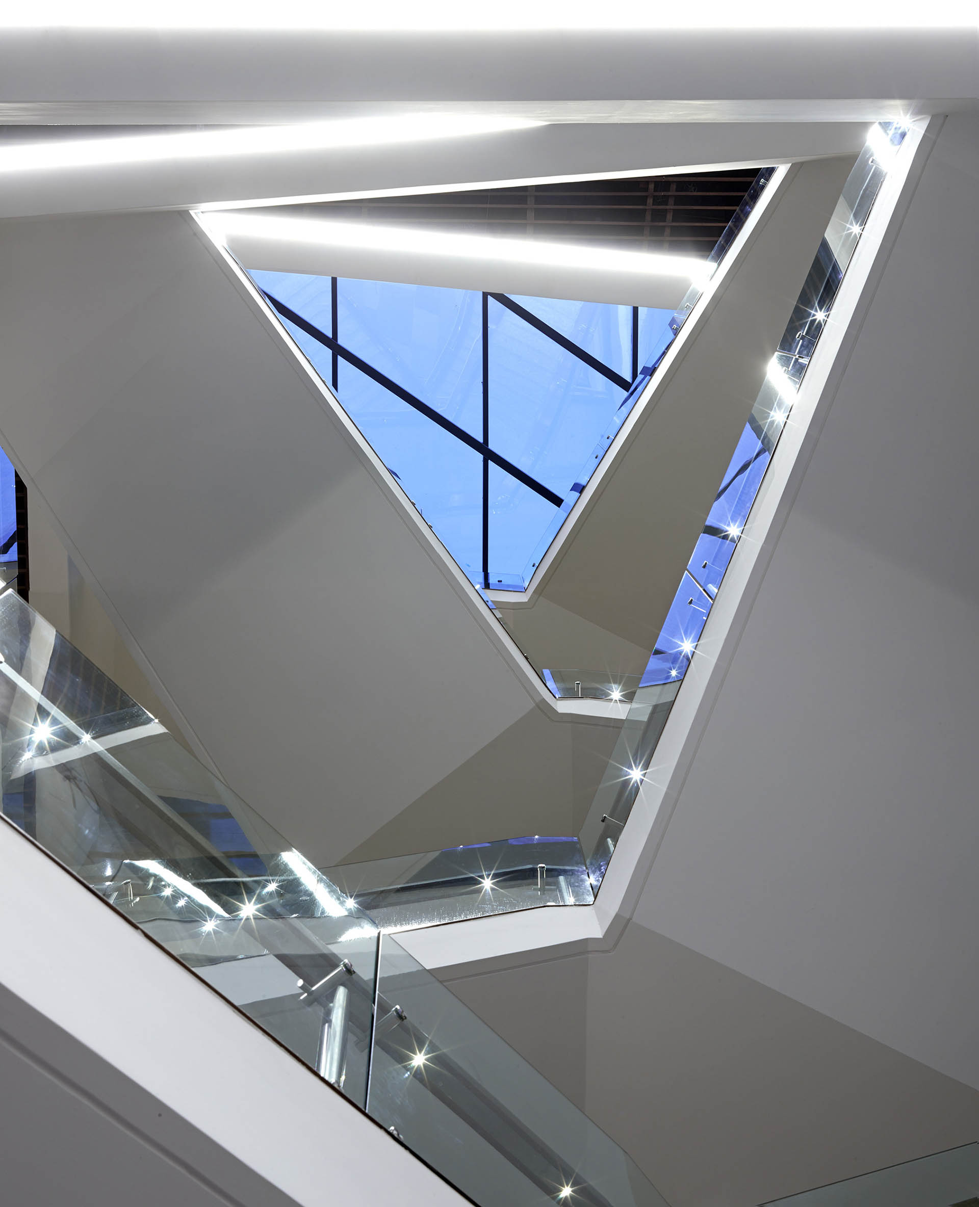 <p>Angled stairs looking up toward roof light.</p>
