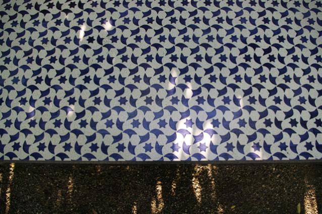 View of blue and white mosaic pattern on garden benches