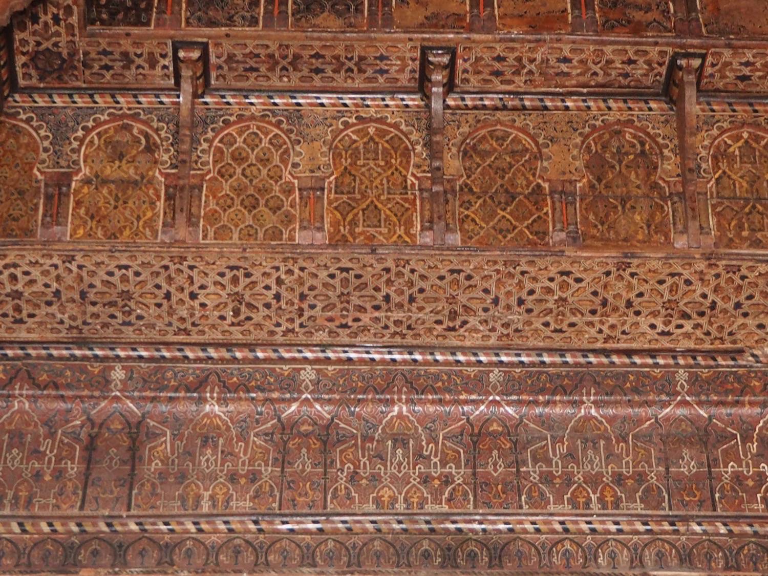 Detail view of the carved, painted wood decoration on the wall