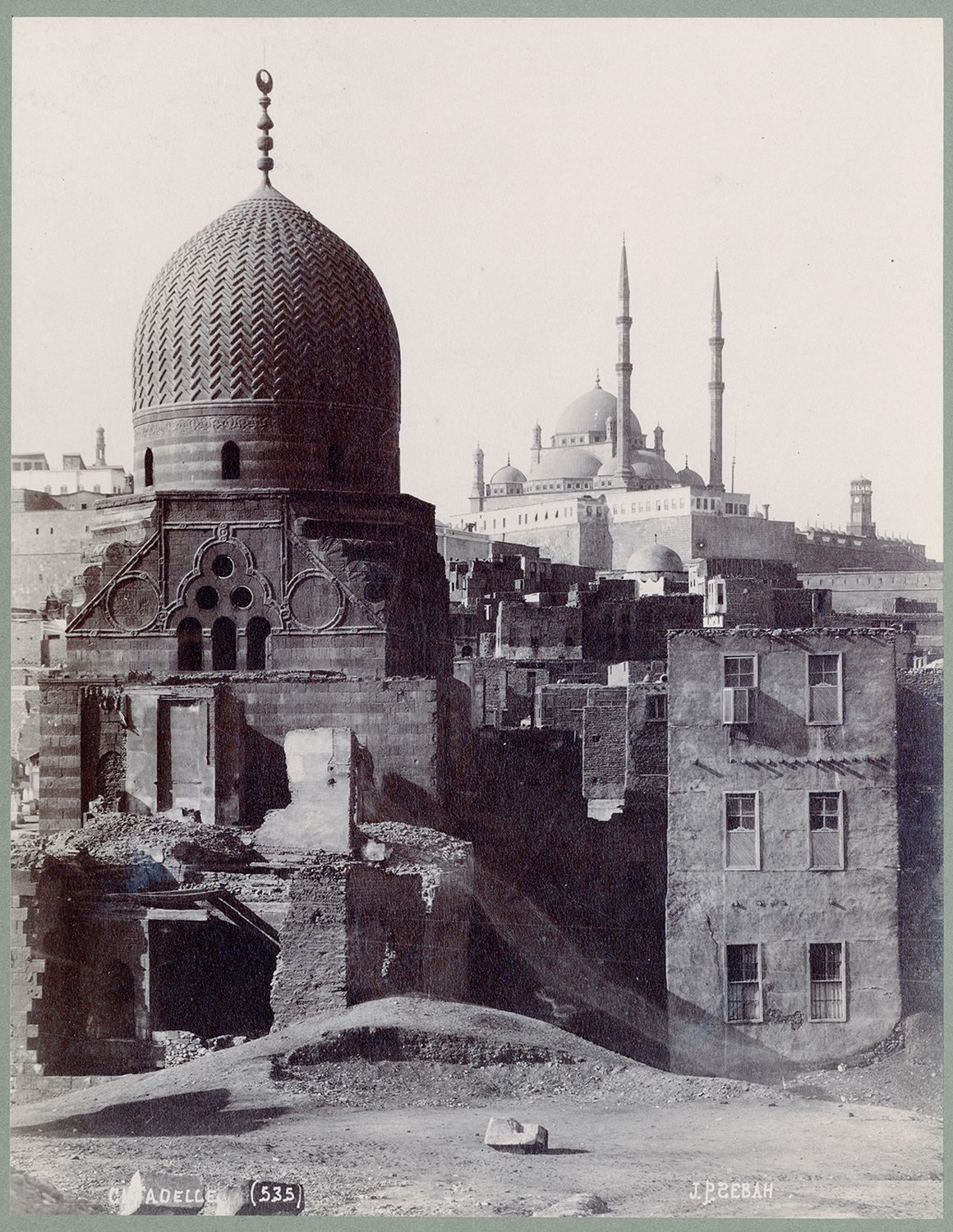 View of mausoleum before restoration. Muhammad Ali Mosque and Citadel visible in background.