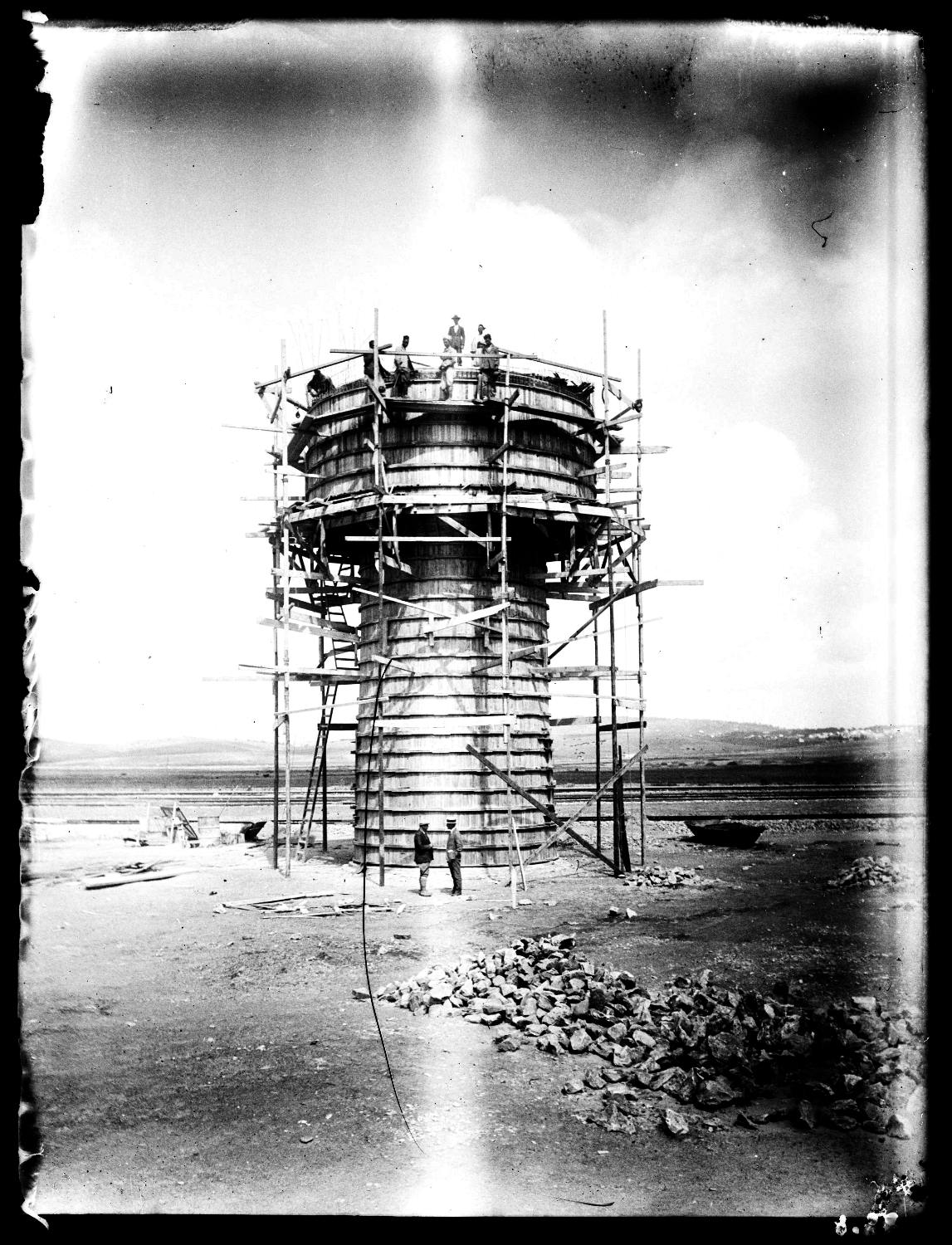Close-up view, construction of water tower with workers on site