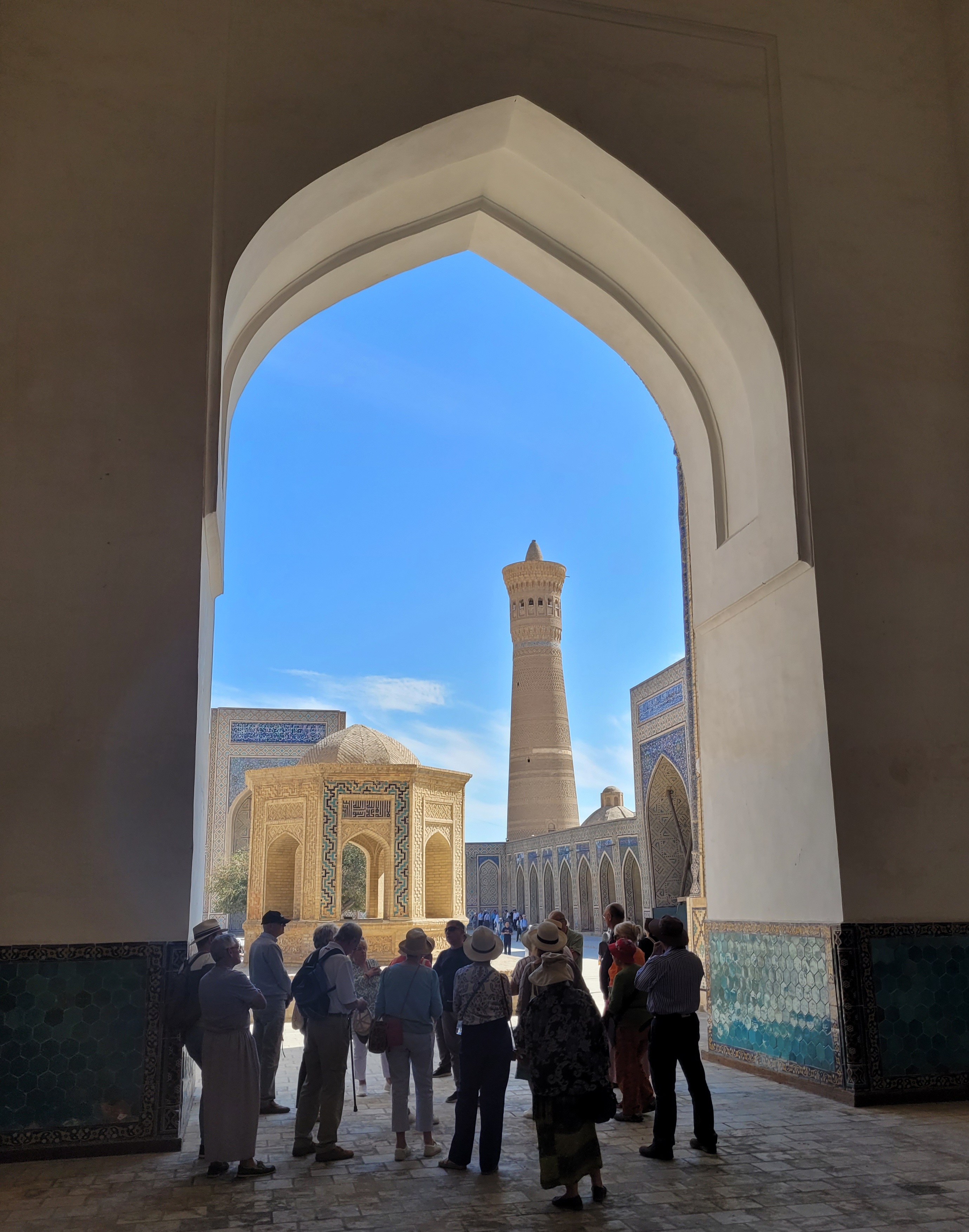<p>The minaret as seen through the arch of the Kalon Mosque</p>