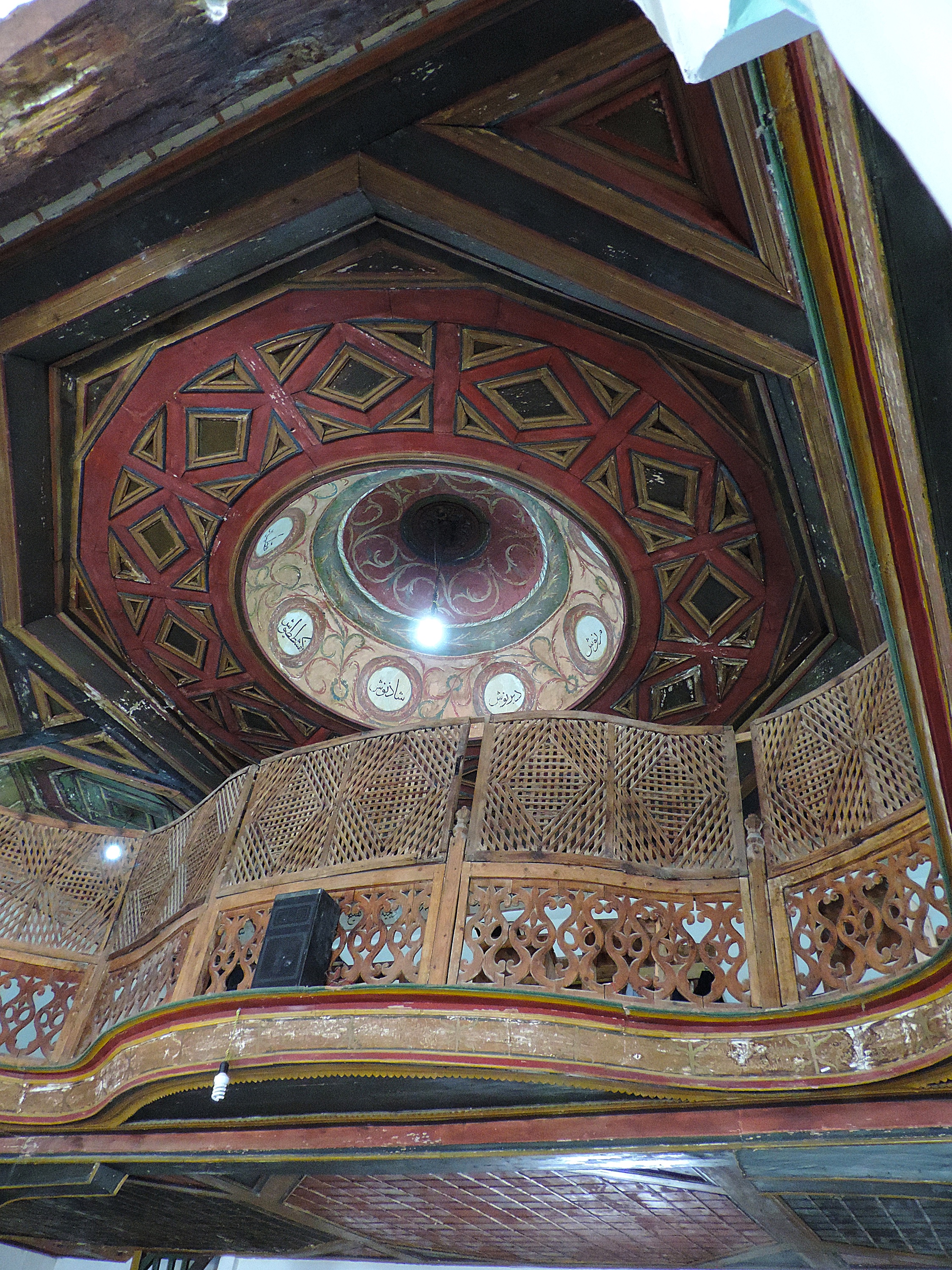 <p>Berat's reputation for woodcarving is revealed in the interior of the Sultan Bayezid II Mosque, of the late 15th century and one of the oldest mosques in Albania. The delicate latticework and tracery of the railing contrasts with the bold angular design of the ceiling that transforms geometrically from the octagonal perimeter to the circular base of the dome.</p>