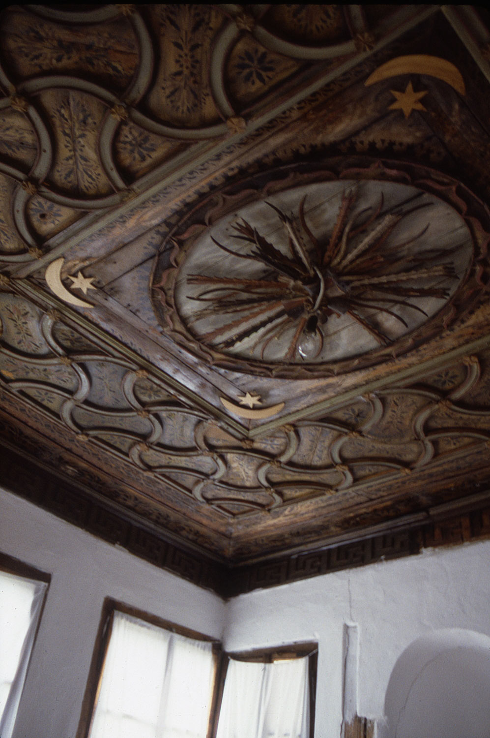 Carved wooden ceiling in a primary guest room