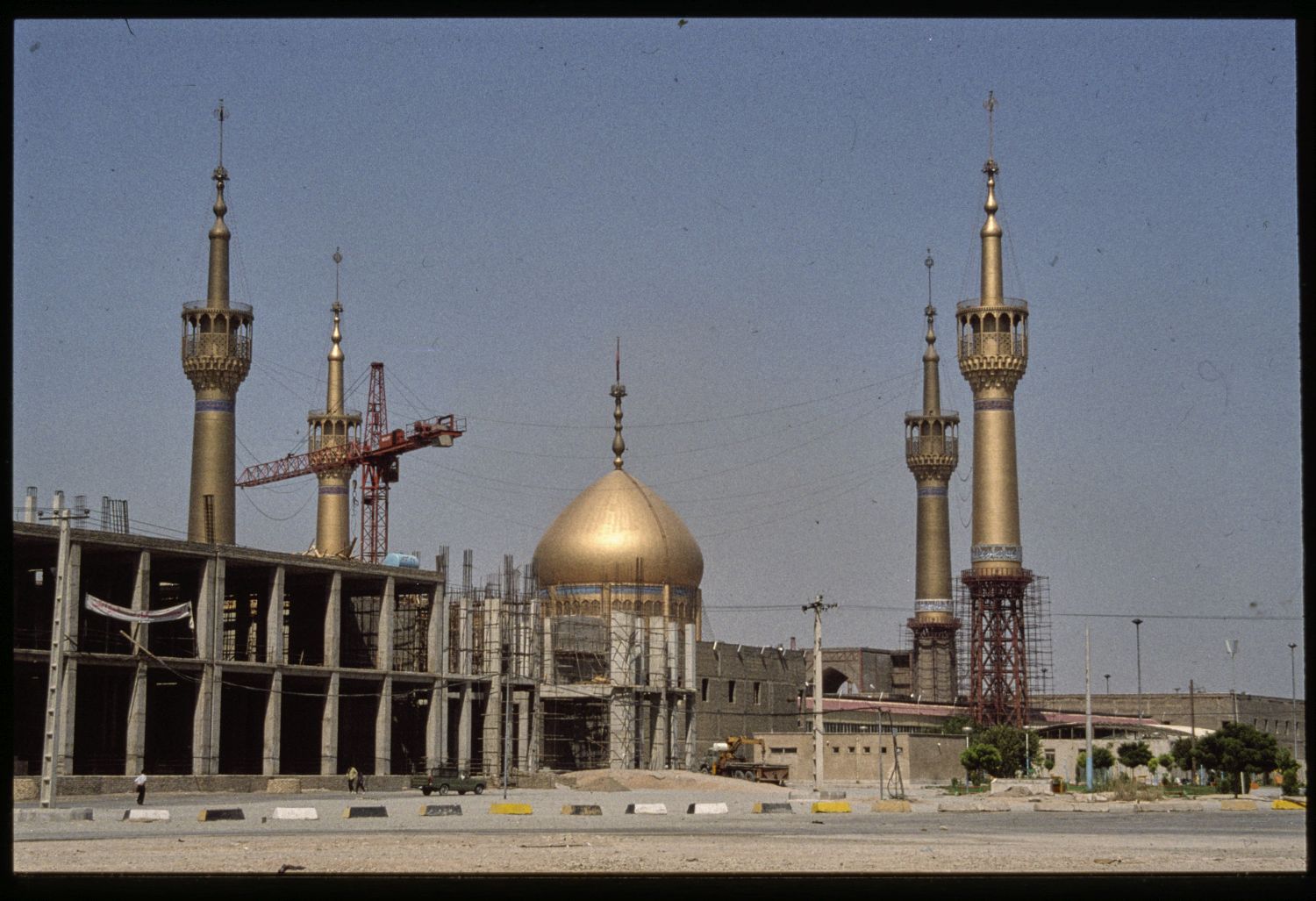 View of dome and minarets beyond construction site.