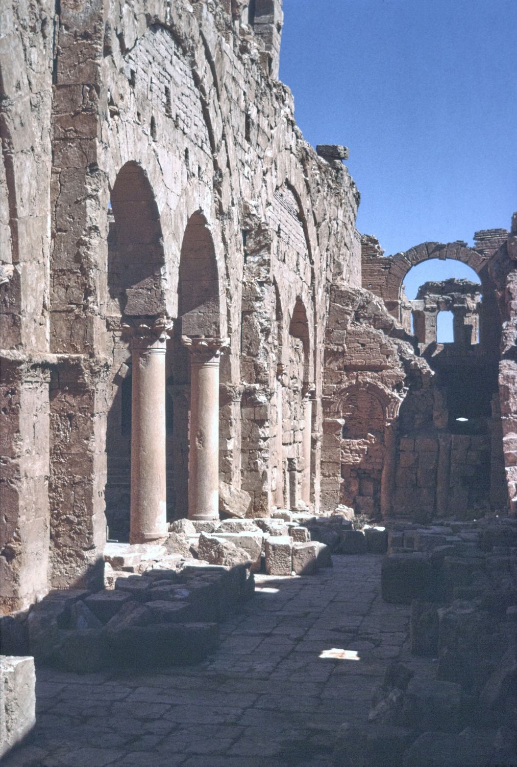 View of south side aisle looking east, showing arcade between side aisle and nave.