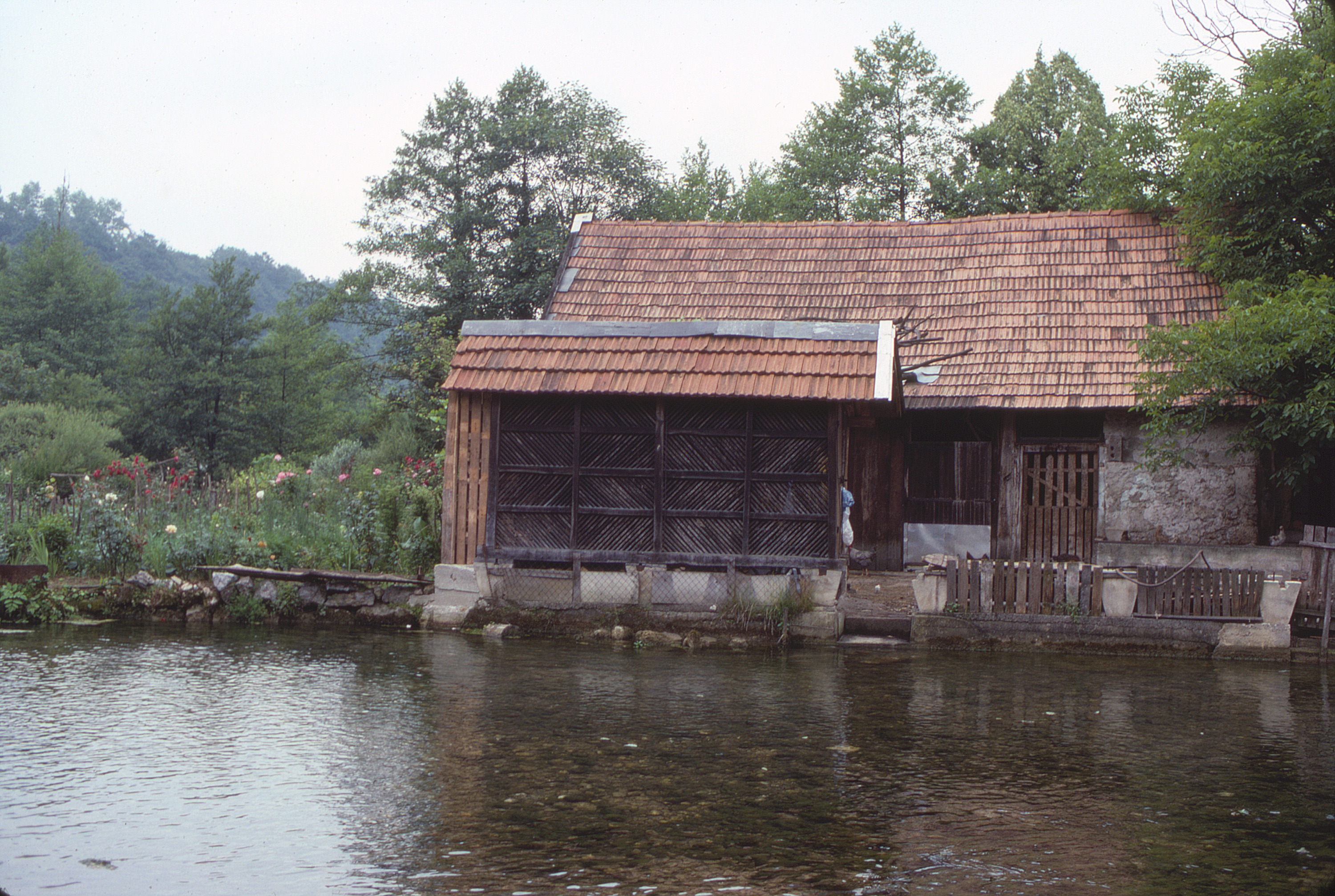 <p>This watermill has several operable openings to chutes that channel water to power the grinding stones within. Beyond the building, which is constructed of stone and wood, the water cascades into the Korana River below.</p>
