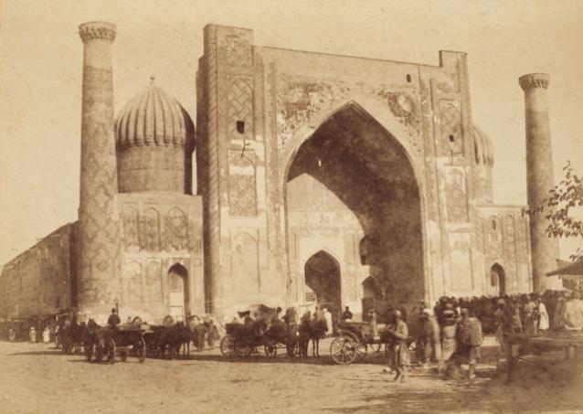Exterior view from Registan Square showing the entrance iwan with the flanking ribbed domes and corner minarets