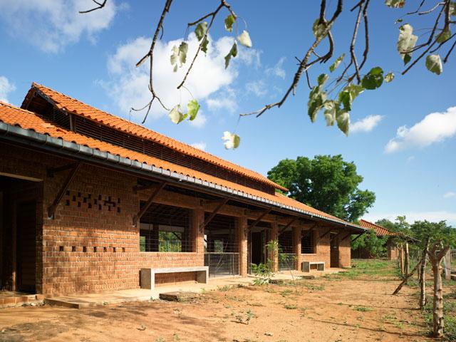 The rear façade of the community building facing the play ground