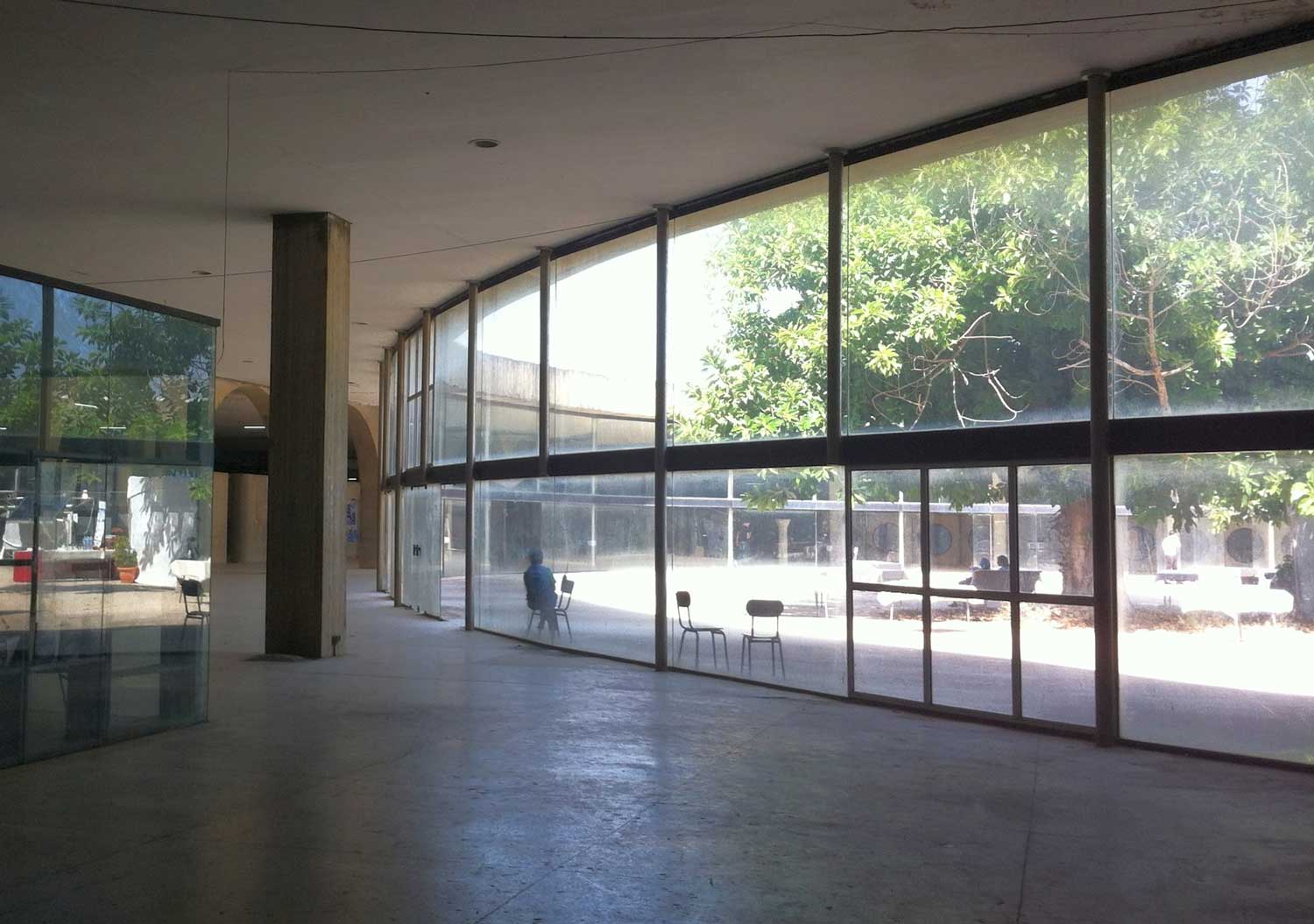Interior view to courtyard through glass wall