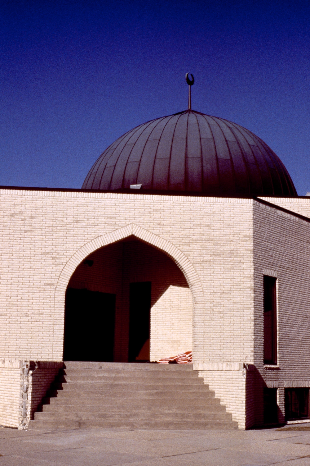 Exterior view of an entrance, with dome above