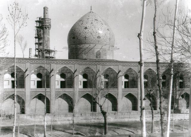 Exterior view looking east from Chahar Bagh Avenue, showing double height  street elevation with porches on the upper floor and arched niches on the lower. The sanctuary dome and minarets are visible in background