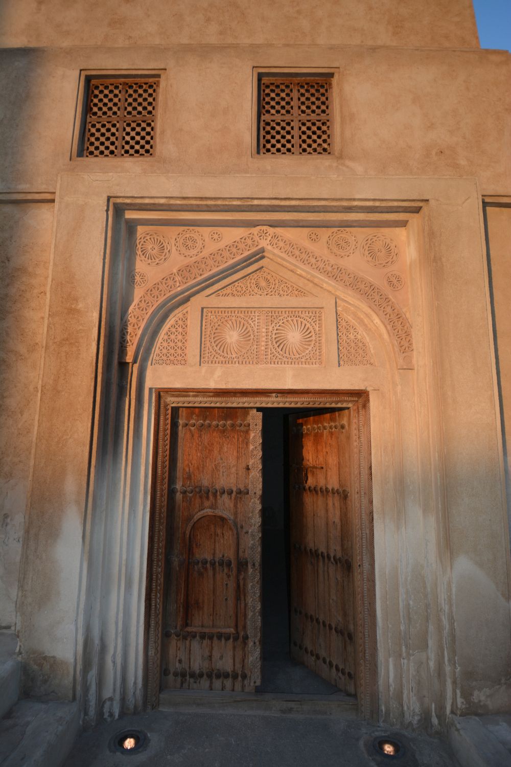 Detail of a doorway with carved ornamentation on the exterior of a building in Muharraq.