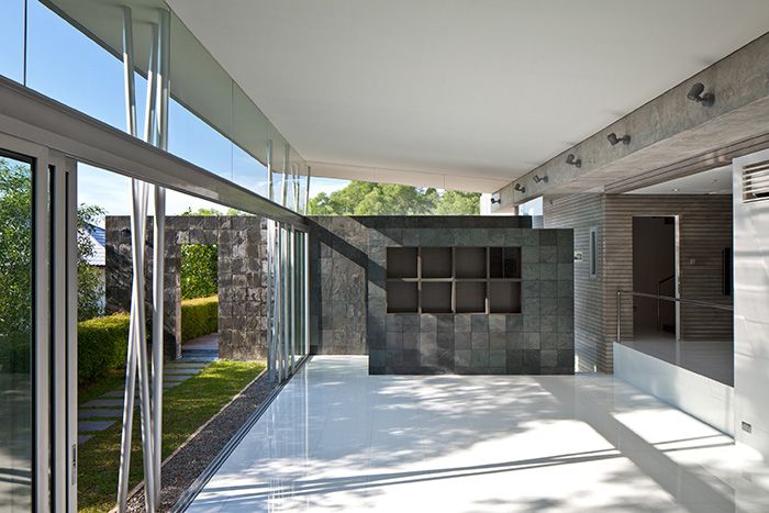 The natural stone landscape wall extended to outside of the house, towards the natural greenery area  