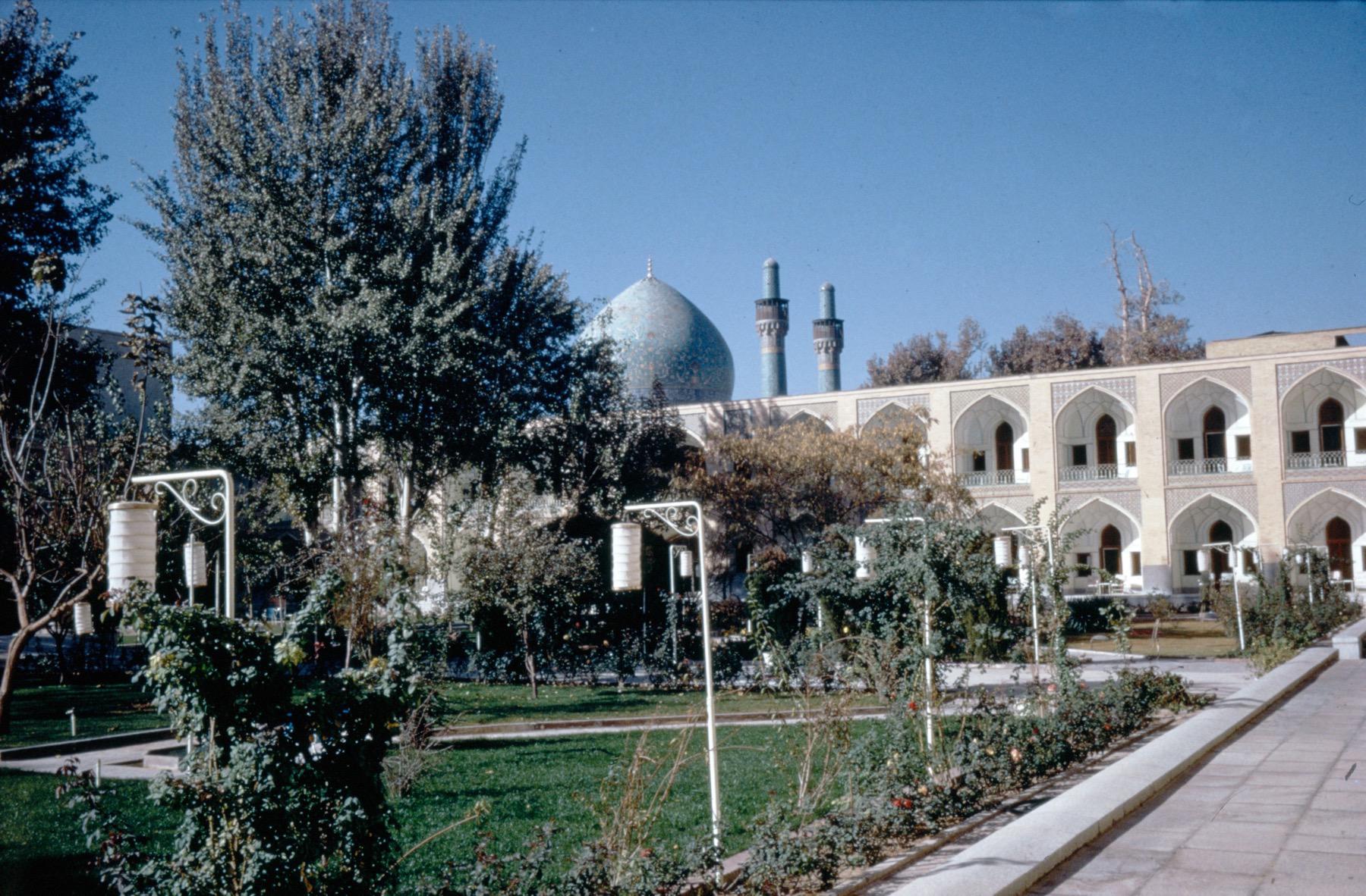 View of former caravanserai courtyard with the dome and minarets of madrasa beyond