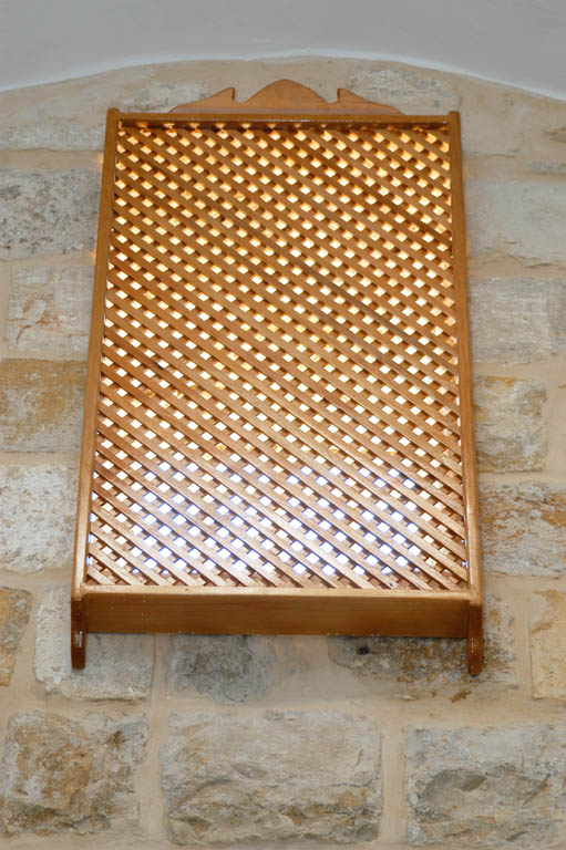 Wood lattice screen over window
