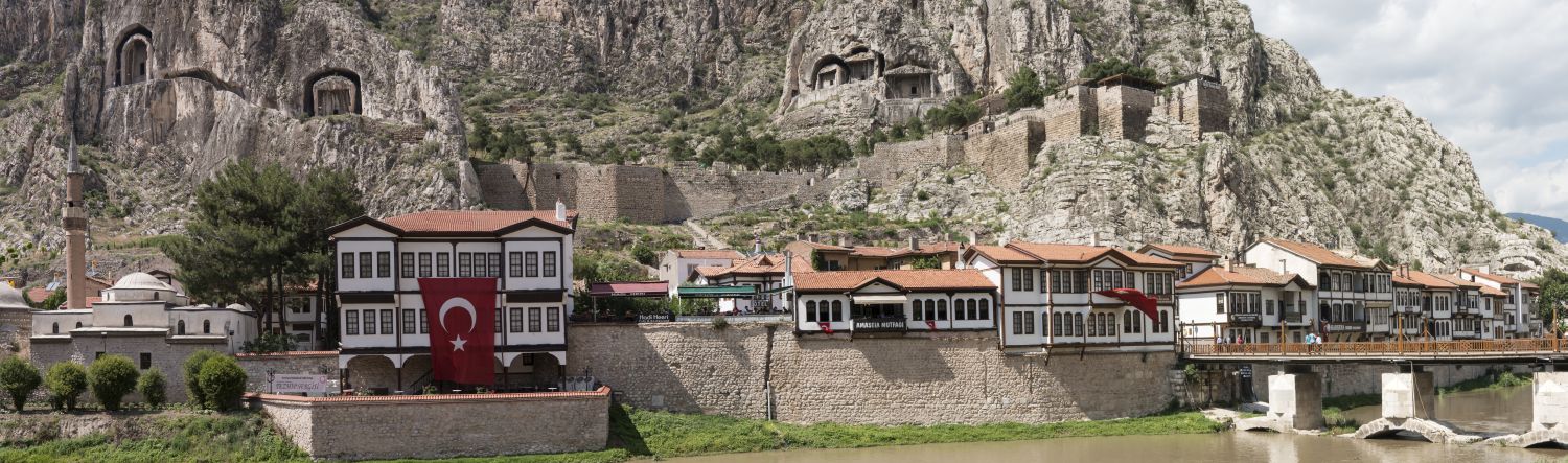 Amasya  - Panoramic view of north bank of Yesilirmak (Green River) in Amasya, Turkey. Ottoman-period riverfront houses are visible in foreground, and above them rises&nbsp;Mount Harşena into which the Kings of Pontus carved rock-cut tombs.