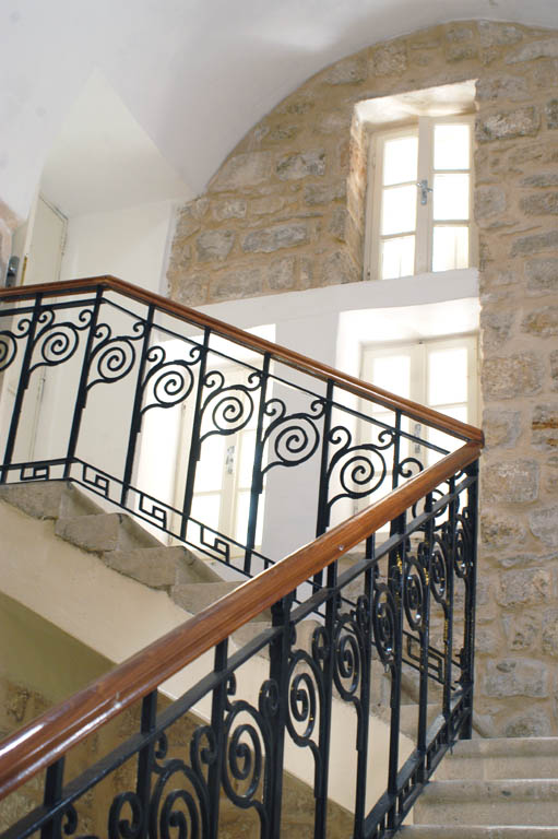 Newly installed wood and iron stair railing
