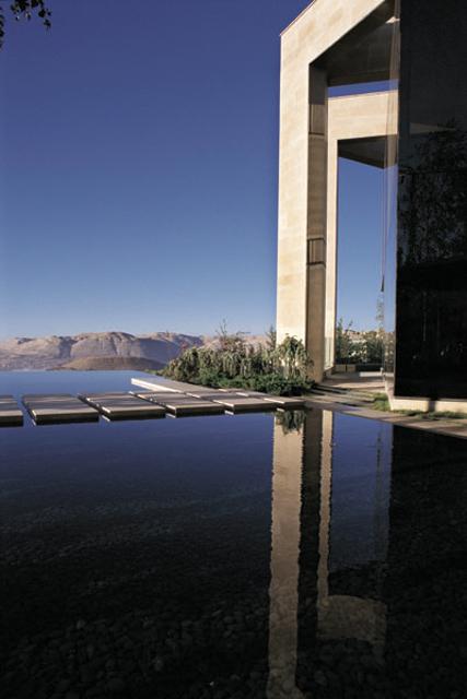 Water mirror reflects the residence, bridging the small site with panoramic views